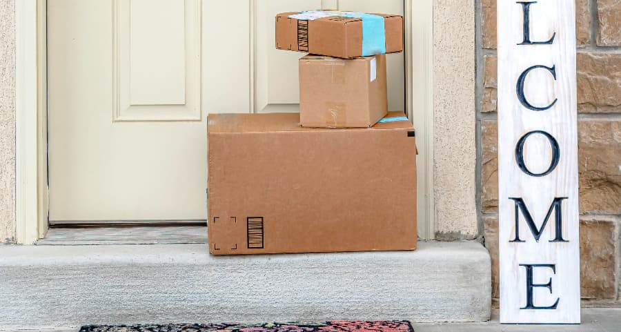 Boxes by the door of a residence with a welcome sign in Buffalo